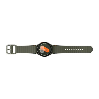 A smartwatch with a dark olive green strap and a black round watch face, featuring a prominent orange accent on the dial and buckle.
